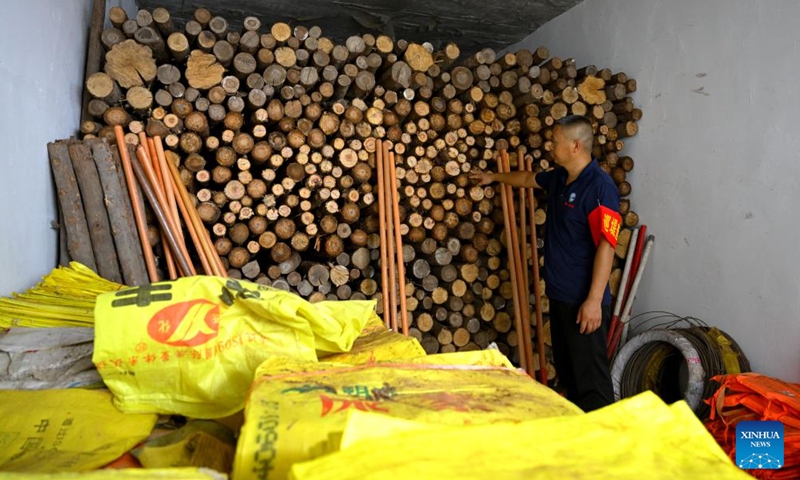 A staff member checks the flood-control materials at Wangjiaba Town, Funan County of Fuyang, east China's Anhui Province, July 14, 2024. Measures including monitoring the flood water, inspecting embankment and ensuring flood-control materials have been taken by the authorities of Funan County of Fuyang, east China's Anhui Province, to control the No. 1 Flood for Huaihe River. (Xinhua/Huang Bohan)