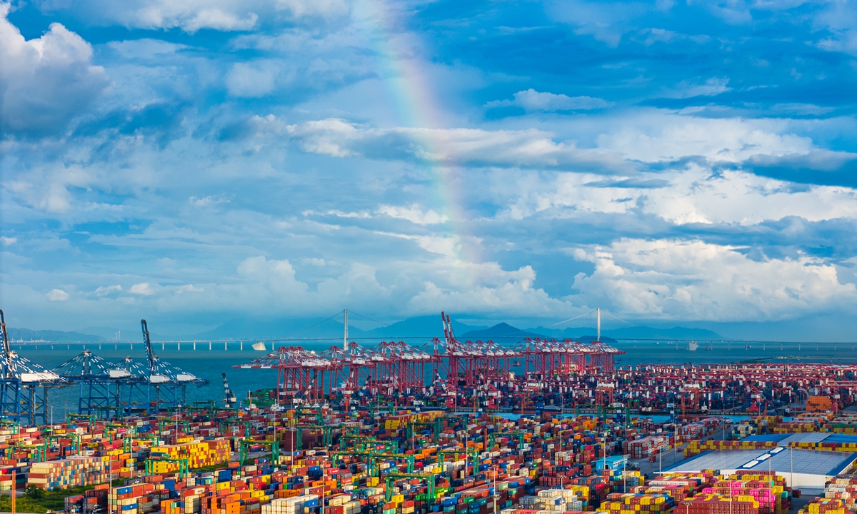 A rainbow crosses the Shenzhen-Zhongshan Bridge in the background as containers of goods at the Nansha Port in Guangzhou, South China's Guangdong Province, are waiting to be transported on July 14, 2024. Photo: VCG