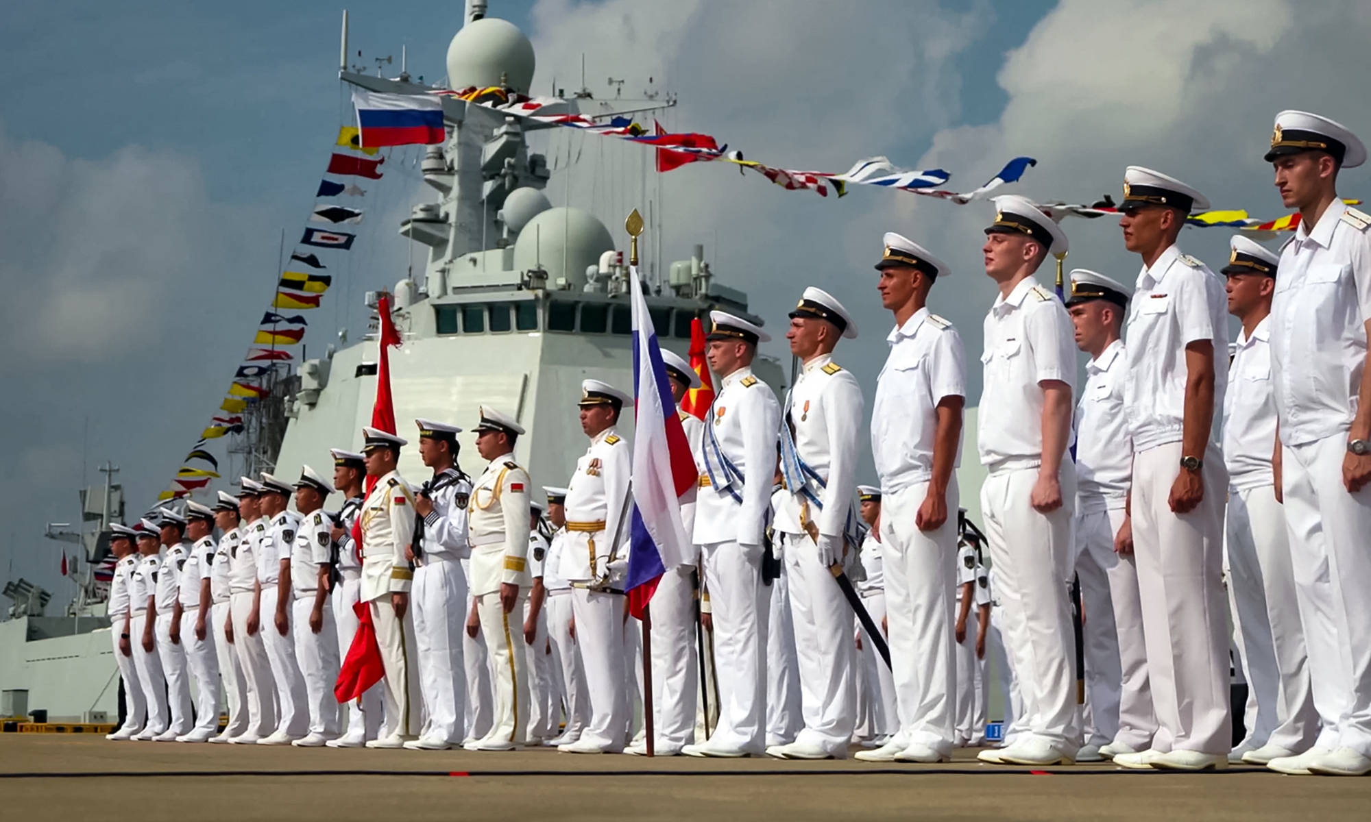 A screenshot of a handout footage released by the Russian Defense Ministry on July 15, 2024 shows Russian and Chinese sailors taking part in the opening ceremony of a joint maritime exercise at a port in Zhanjiang, South China's Guangdong province. Photo: AFP
