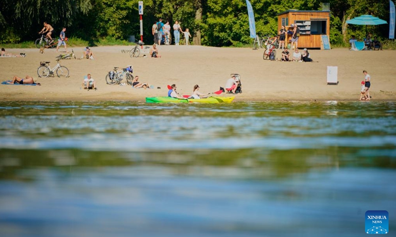 People cool themselves off along the Vistula River in Warsaw, Poland, July 14, 2024. (Photo by Jaap Arriens/Xinhua)