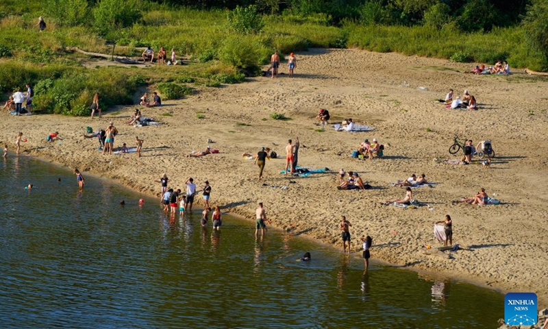 People cool themselves off along the Vistula River in Warsaw, Poland, July 14, 2024. (Photo by Jaap Arriens/Xinhua)