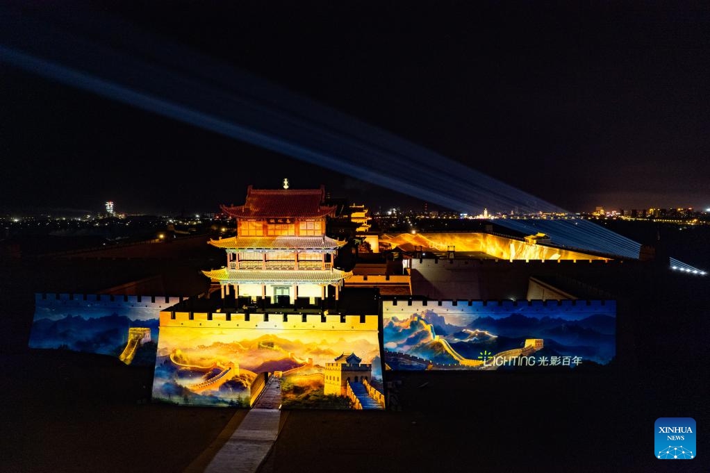 A drone photo taken on July 14, 2024 shows ancient city walls lit up at night at the Jiayu Pass scenic area in the city of Jiayuguan, northwest China's Gansu Province. The Jiayu Pass is the starting point of a section of the Great Wall constructed during the Ming Dynasty (1368-1644). The pass also served as a vital passage on the ancient Silk Road. (Photo: Xinhua)