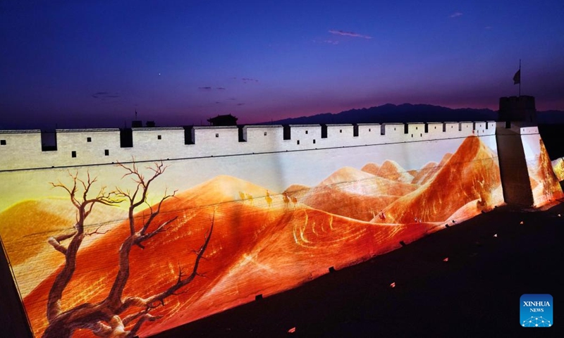 This photo taken on July 14, 2024 shows an ancient city wall lit up at night at the Jiayu Pass scenic area in the city of Jiayuguan, northwest China's Gansu Province. The Jiayu Pass is the starting point of a section of the Great Wall constructed during the Ming Dynasty (1368-1644). The pass also served as a vital passage on the ancient Silk Road. (Photo: Xinhua)