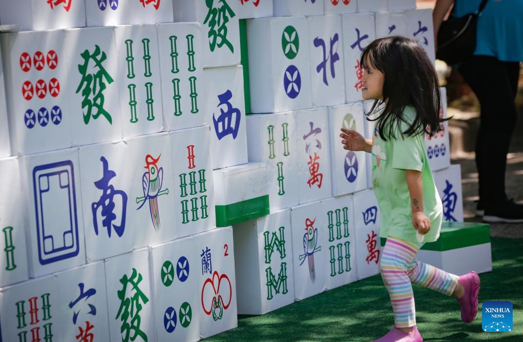 A girl walks past the giant Mahjong tiles during the 2024 Chinatown Festival in Vancouver, British Columbia, Canada, July 14, 2024. (Photo: Xinhua)