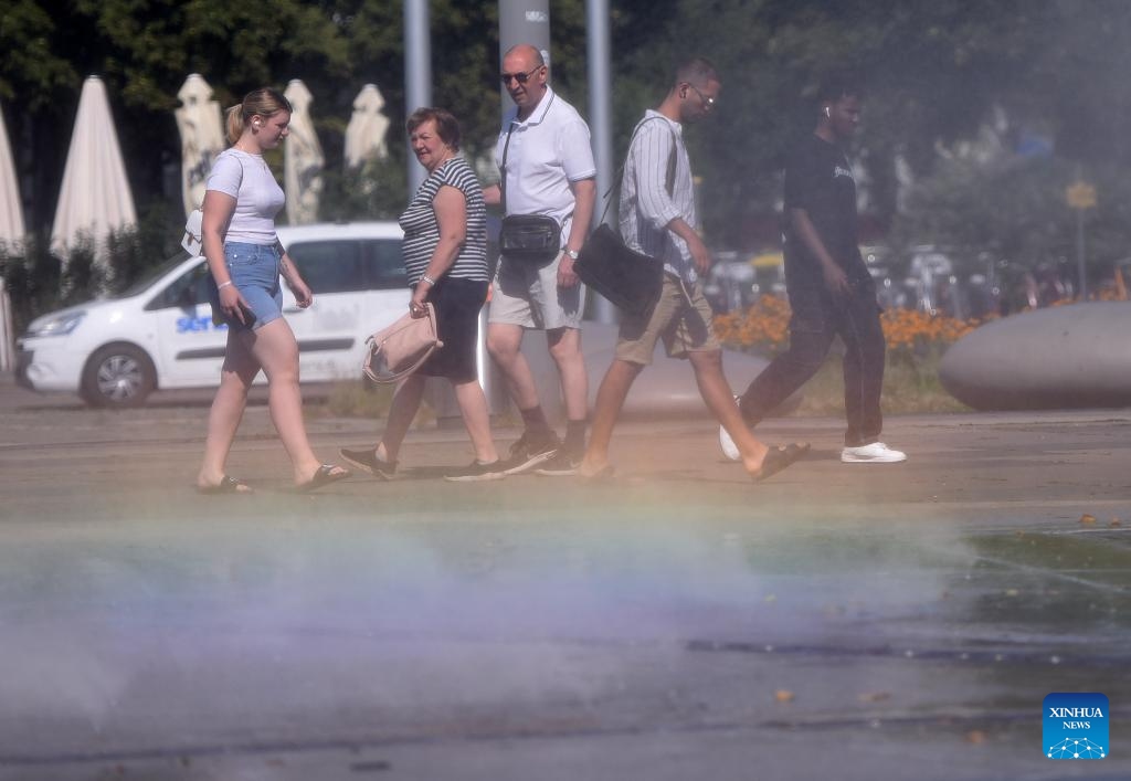 People walk past a spray installation in Vienna, Austria, July 16, 2024. (Photo: Xinhua)