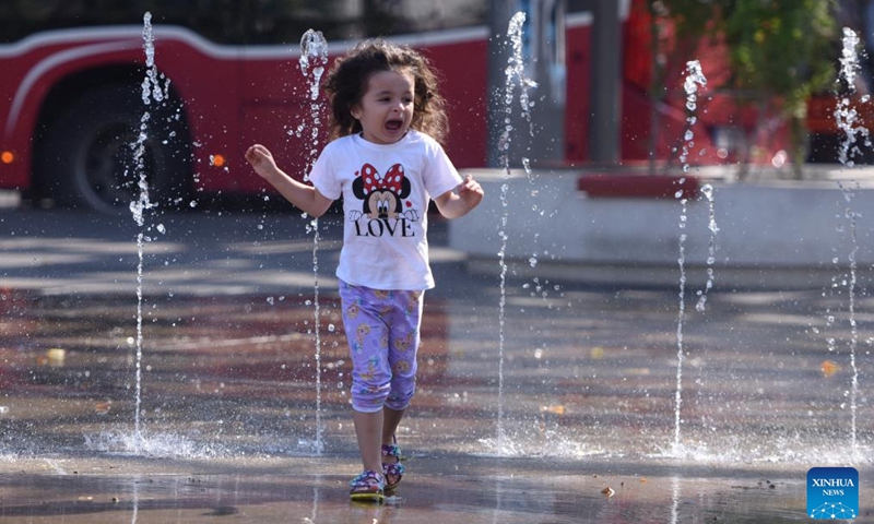 A kid plays at a spray installation in Vienna, Austria, July 16, 2024. (Photo: Xinhua)