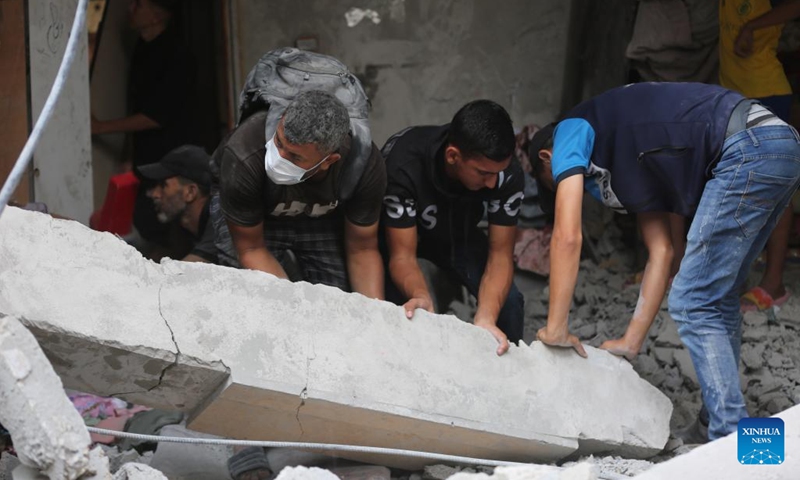 People search among the rubble after an Israeli airstrike in the Nuseirat refugee camp in central Gaza, on July 16, 2024. During the past 24 hours, the Israeli military killed 49 people and wounded 69 others, bringing the total death toll to 38,713 and injuries to 89,166 since the Palestinian-Israeli conflict broke out in early October 2023, Gaza-based health authorities said in a statement on Tuesday. (Photo: Xinhua)