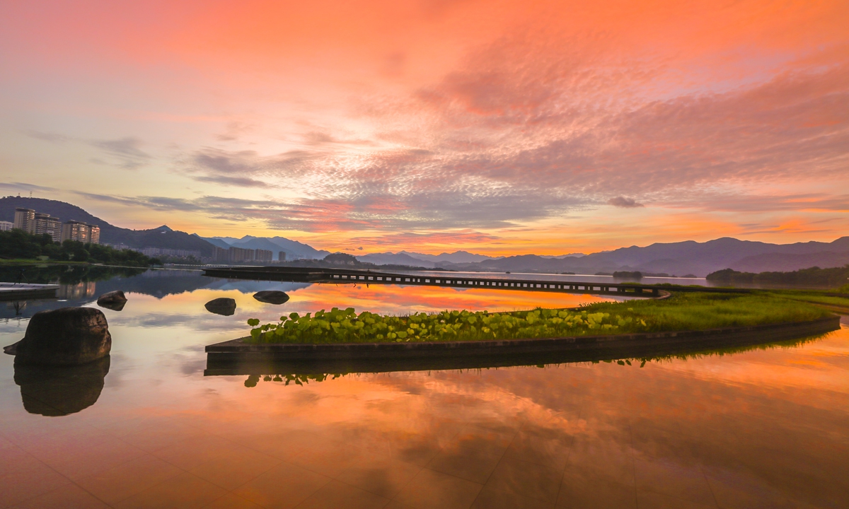 Qiandao Lake in East China's Zhejiang Province welcomes a brilliant sunrise, with the sunlight reflecting the sky, on July 16, 2024. Photo: VCG