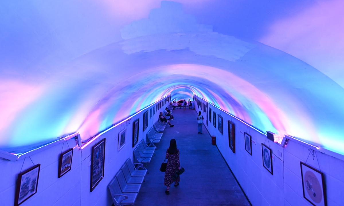 Citizens cool off in an refurbished air-raid shelter built during WWII in Southwest China's Chongqing Municipality on July 17, 2024. As Chongqing has issued an orange high-temperature warning, 39 air-raid shelters in the city's 11 districts have been opened to the public for free so they may escape the summer heat. Photo: VCG