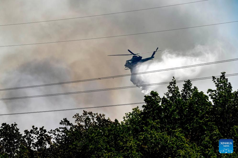 A plane drops water during firefighting above the Serta mountain near Negotino, North Macedonia on July 16, 2024. (Photo: Xinhua)