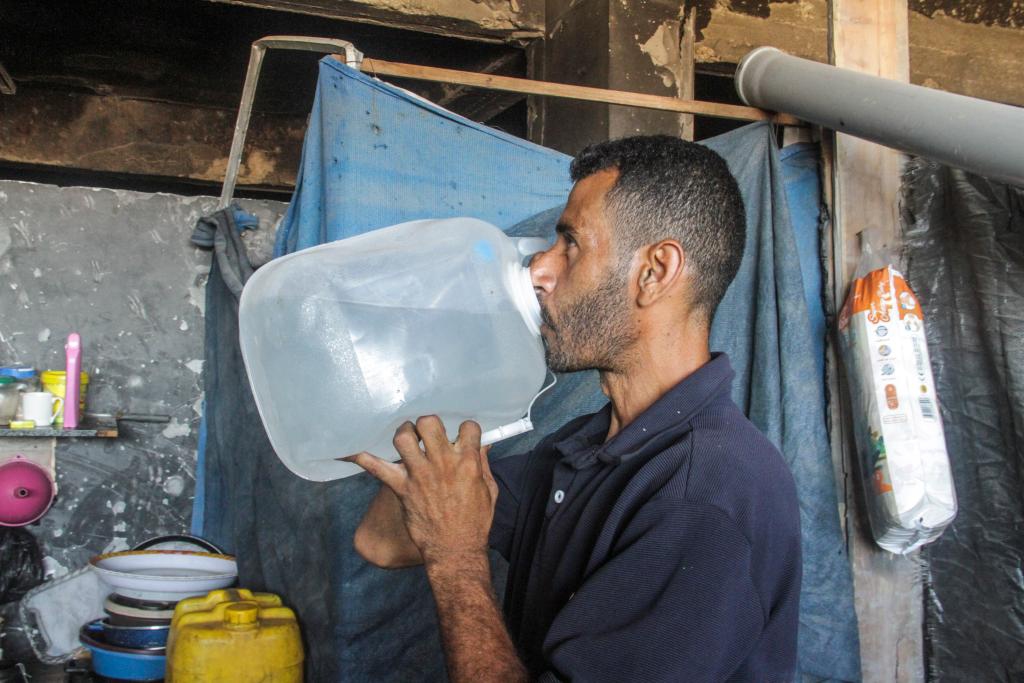 A family member of Ahmed Shinbari drinks water in the northern parts of Gaza, on July 17, 2024. About 67 percent of water, sanitation facilities and infrastructure have been destroyed or damaged in the Gaza Strip, the United Nations Relief and Works Agency for Palestine Refugees in the Near East (UNRWA) said on the social media platform X in June. (Photo: Xinhua)