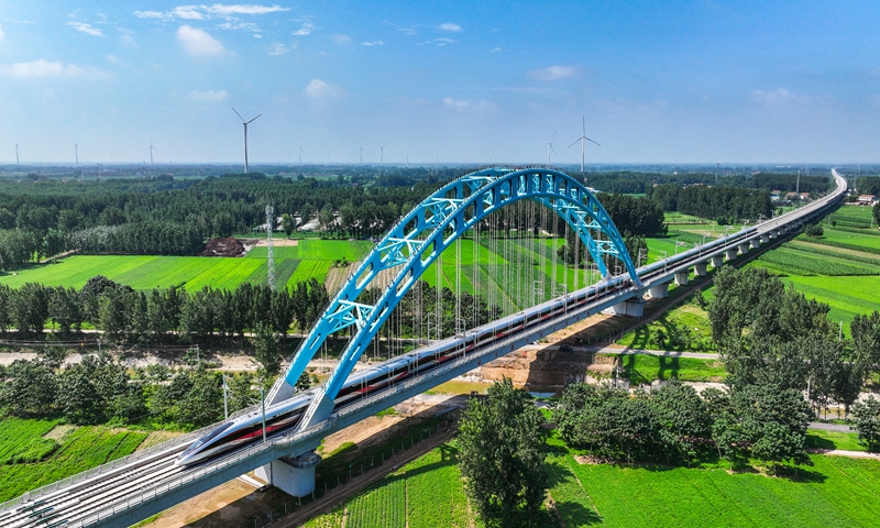 A high-speed train runs through a viaduct on the Rizhao-Lankao high-speed railway line in Lankou county, Central China's Henan Province, on July 18, 2024. The railway, which reached full operation for the first time on that day, links Rizhao in East China's Shandong Province and Lankao, offering a travel time for the nearly 500-kilometer journey of two hours and a half, compared with about five hours by car. Photo: VCG