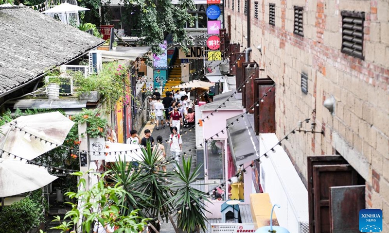 Tourists visit the Beicang Cultural and Creative Street in Jiangbei District of southwest China's Chongqing, July 15, 2024. Through urban renewal efforts in recent years, many old streets, neighborhoods and factories in Jiangbei District have been mapped out artistically and commercially. The creative renovation and upgrading brings more business opportunities to tap the potential, and attracts young people to experience the vibe, infusing more vigor into the areas. (Photo: Xinhua)