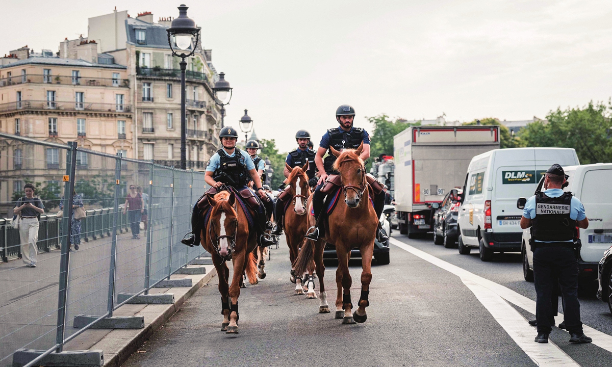 Lekhwiya Qatar International Security Force and French Gendarmes patrol on horses down a street in the center of Paris on July 19, 2024, ahead of the opening ceremony of the Paris 2024 Olympic Games, which will take place on July 26 along the Seine. Photo: VCG