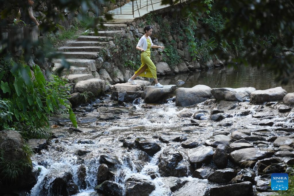 A tourist walks in Songzhuang Village of Songyang County, east China's Zhejiang Province, July 17, 2024. Nestled in the mountains, Songzhuang Village of Songyang County boasts a history of over 600 years and preserves many traditional residences. In recent years, local government has renovated old houses and ancient paths and introduced new business forms to attract young talents to start their businesses there. (Photo: Xinhua)