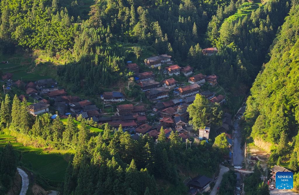 This aerial drone photo taken on July 11, 2024 shows a view of the Wuying Village at sunrise on the border between south China's Guangxi Zhuang Autonomous Region and southwest China's Guizhou Province. Wuying Village, spanning a history of over 200 years, is a Miao ethnic group hamlet that nestles snugly in the towering mountains stretching across the border between Guangxi and Guizhou. (Photo: Xinhua)