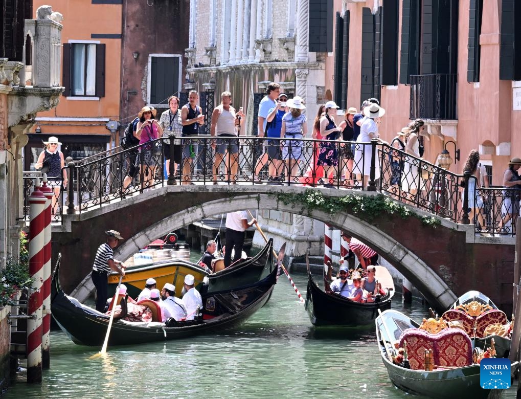 Tourists are seen sightseeing by gondola in Venice, Italy, July 18, 2024. (Photo: Xinhua)