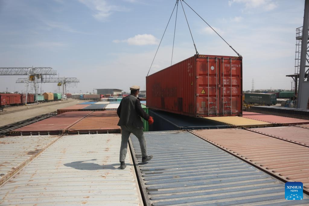 This photo taken on March 10, 2024 shows a view of the Hairatan land port, Balkh Province, north Afghanistan. The clatter of trains, the sight of scattered containers, and the lines of trucks awaiting goods in the Hairatan land port of north Afghanistan present a stark contrast to the country's economic challenges. Each day, thousands of people are busily working here to support their families. (Photo: Xinhua)