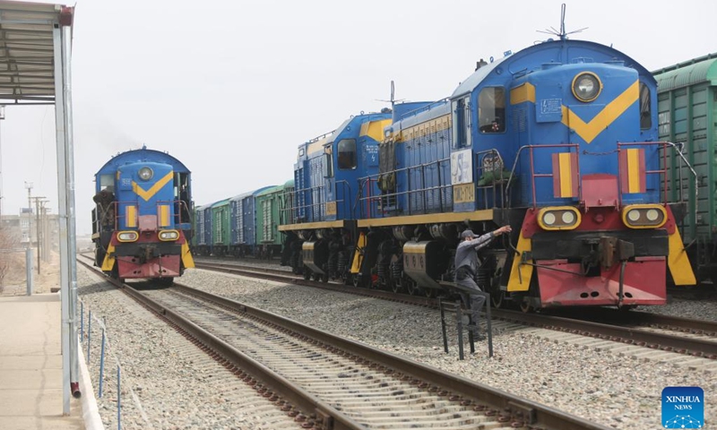 This photo taken on March 10, 2024 shows trains at the Hairatan land port, Balkh Province, north Afghanistan. The clatter of trains, the sight of scattered containers, and the lines of trucks awaiting goods in the Hairatan land port of north Afghanistan present a stark contrast to the country's economic challenges. Each day, thousands of people are busily working here to support their families. (Photo: Xinhua)