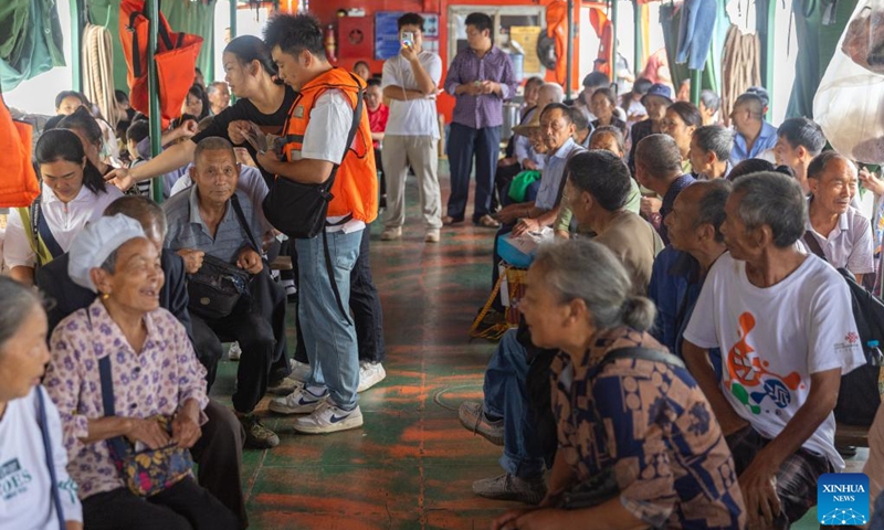 Passengers talk to each other on Yu Zhong Ke 2180 ferry in southwest China's Chongqing Municipality, July 10, 2024. Yu Zhong Ke 2180 ferry remains the last water bus running between Yangdu and Xishan wharfs in Zhongxian County of Chongqing. (Photo: Xinhua)