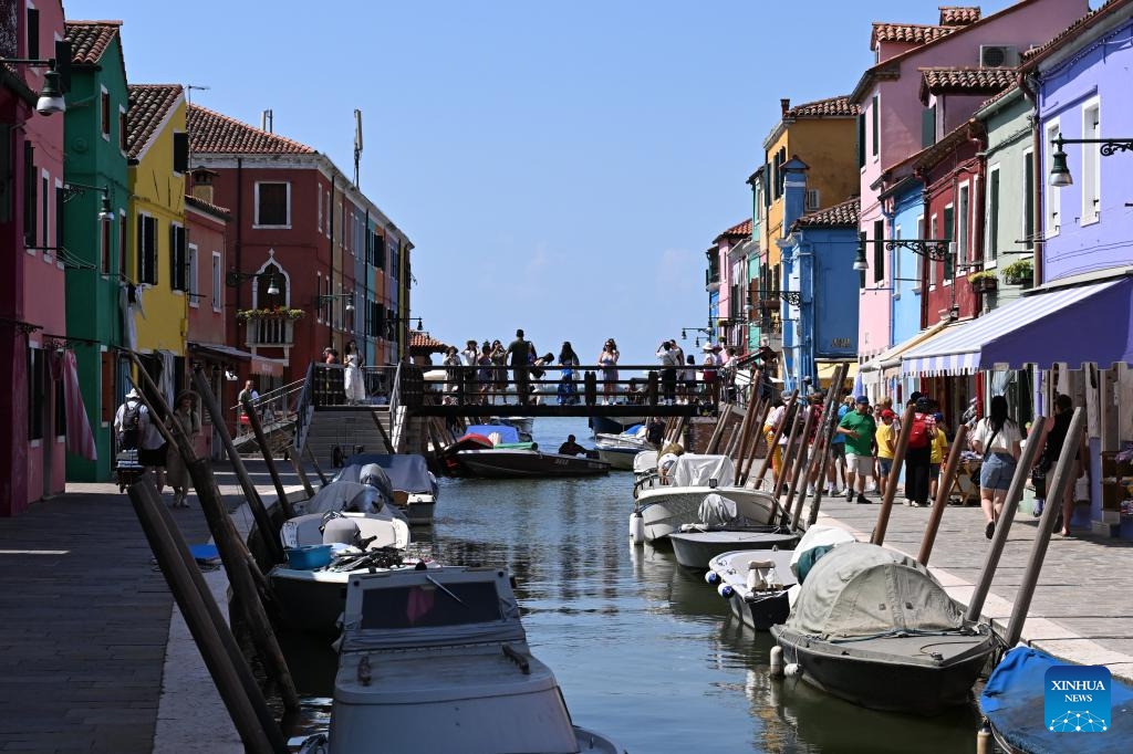 Tourists visit the colorful houses in Burano island, Venice, Italy, July 18, 2024. (Photo: Xinhua)