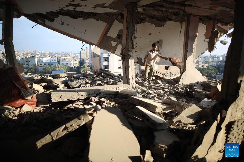 A man collects items from the rubble at the Nuseirat refugee camp in central Gaza, on July 18, 2024. During the past 24 hours, the Israeli military killed 54 people and wounded 95 others, bringing the total Palestinian death toll to 38,848 and injuries to 89,459 since the conflict broke out in early October 2023, the Gaza-based health authorities said in a statement on Thursday. (Photo: Xinhua)