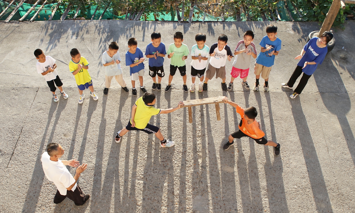 Children practice martial arts under the guidance of a folk martial artist in a village in Yichun, East China's Jiangxi Province, on July 22, 2024. During the summer vacation, many young people from surrounding towns and villages come to participate in the folk martial arts class, experiencing the charm of traditional Chinese martial arts. Photo: VCG