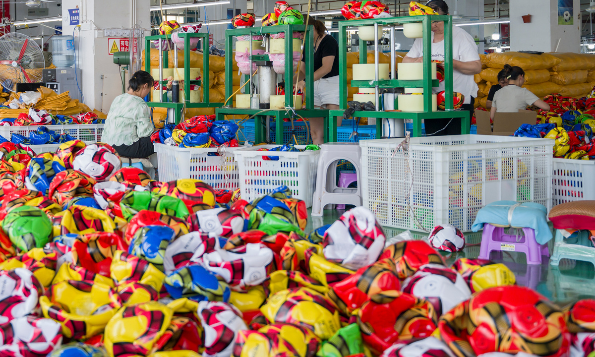 Workers from a sports equipment manufacturing company in the Daping Industrial Park in Zunyi, Southwest China's Guizhou Province, produce footballs on July 22, 2024. The production line is busy with customers' orders. Photo: cnsphoto