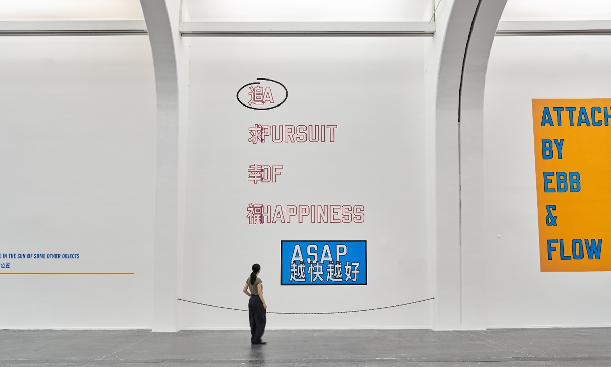 A visitor explores the exhibition titled <em>Lawrence Weiner</em>: A Pursuit of Happiness ASAP at the Center for Contemporary Art (UCCA) in Beijing Photo: Courtesy of UCCA