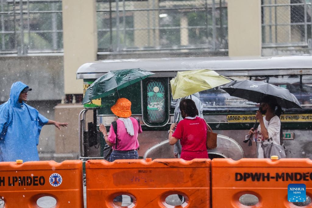 People use umbrellas to avoid the heavy rain brought by typhoon Gaemi in Quezon City, the Philippines, July 22, 2024. (Photo: Xinhua)