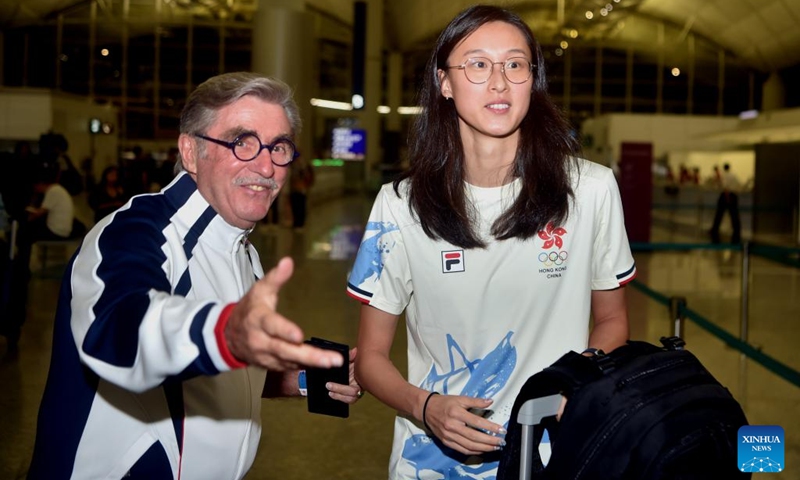 Thomas Brian Stevenson (L), head of the delegation of China's Hong Kong, reacts with athlete Karen Tam Hoi Lam before the departure for Paris 2024 Olympic Games at the Hong Kong International Airport in Hong Kong, south China, July 22, 2024. (Xinhua/Lo Ping Fai)