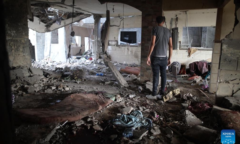 A Palestinian inspects a destroyed residential apartment after an Israeli airstrike in the Nuseirat refugee camp in central Gaza, July 21, 2024. The Israeli army has bombed the central Gazan refugee camp of Nuseirat 63 times in seven days, killing 91 Palestinians and injuring 251 others, the Hamas-run Gaza government media office said Sunday. (Photo: Xinhua)