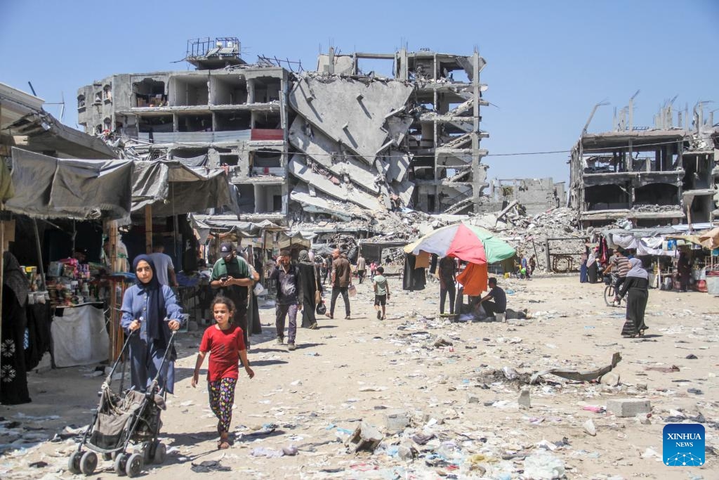 People are seen among rubble in the Jabalia refugee camp, northern Gaza Strip, on July 21, 2024. (Photo: Xinhua)