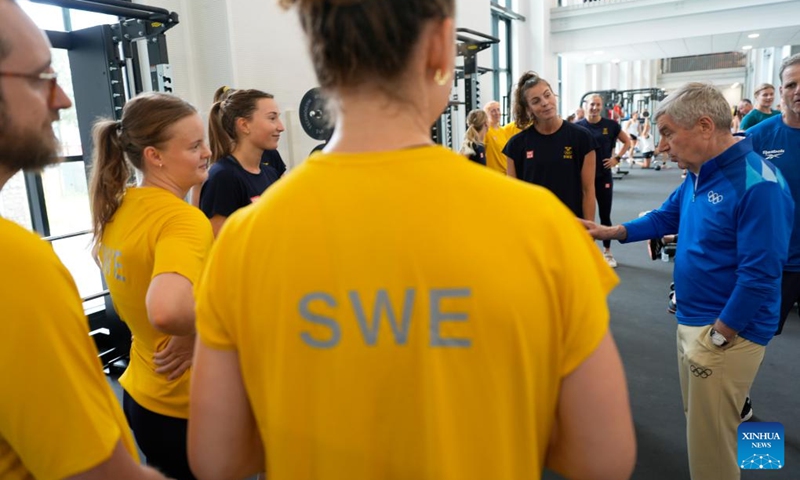 IOC President Thomas Bach (1st R) talks to members of the Sweden women's handball team in the gym at the Olympic Village ahead of the Paris 2024 Olympic Games, on July 22, 2024, in Paris, France. (Photo by David Goldman/POOL/Xinhua)