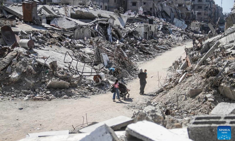 People are seen among rubble in the Jabalia refugee camp, northern Gaza Strip, on July 21, 2024. (Photo: Xinhua)