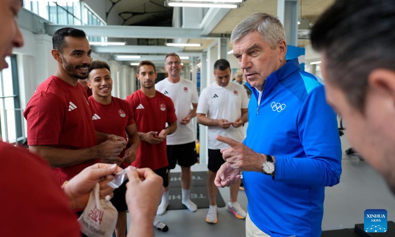 IOC President Thomas Bach (1st R) talks to members of the Turkey men's artistic gymnastics team as he tours the gym at the Olympic Village ahead of the Paris 2024 Olympic Games, on July 22, 2024, in Paris, France. (Photo by David Goldman/POOL/Xinhua)