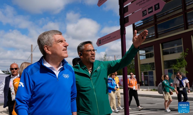 IOC President Thomas Bach (L) tours the Olympic Village ahead of the Paris 2024 Olympic Games, on July 22, 2024, in Paris, France. (Photo by David Goldman/POOL/Xinhua)