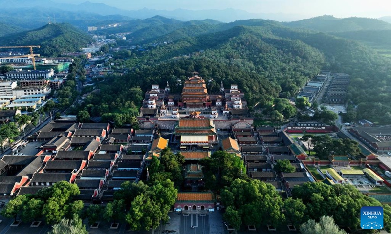 An aerial drone photo taken on July 20, 2024 shows a view of the Puning Temple in Chengde City, north China's Hebei Province. Chengde, a popular summer tourism destination approximately 230 km north of the Chinese capital Beijing, is an important transportation hub in north China. The city with profound cultural heritage is a place where nomadic culture, farming culture, royal culture and folk culture blend together. (Photo: Xinhua)