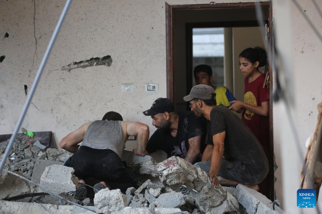 Palestinians inspect a destroyed residential apartment after an Israeli airstrike in the Nuseirat refugee camp in central Gaza, July 21, 2024. The Israeli army has bombed the central Gazan refugee camp of Nuseirat 63 times in seven days, killing 91 Palestinians and injuring 251 others, the Hamas-run Gaza government media office said Sunday. (Photo: Xinhua)