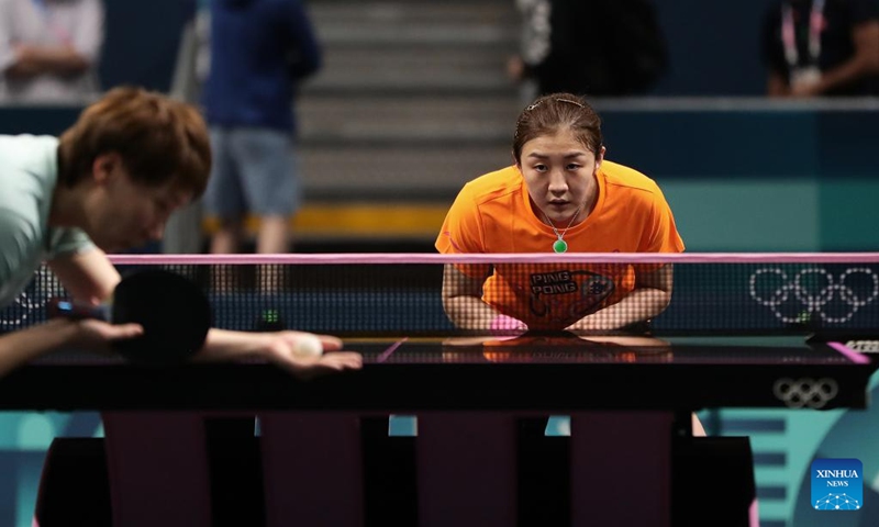 Chen Meng (R) and Wang Manyu of the Chinese national table tennis team attend a training session for Paris 2024 in South Paris Arena, Paris, France, July 22, 2024. (Xinhua/Wang Dongzhen)