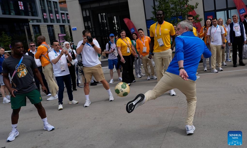 IOC President Thomas Bach (front R) interacts with South African hockey player Zenani Kraai (front L) while touring the Olympic Village ahead of the Paris 2024 Olympic Games, on July 22, 2024, in Paris, France. (Photo by David Goldman/POOL/Xinhua)