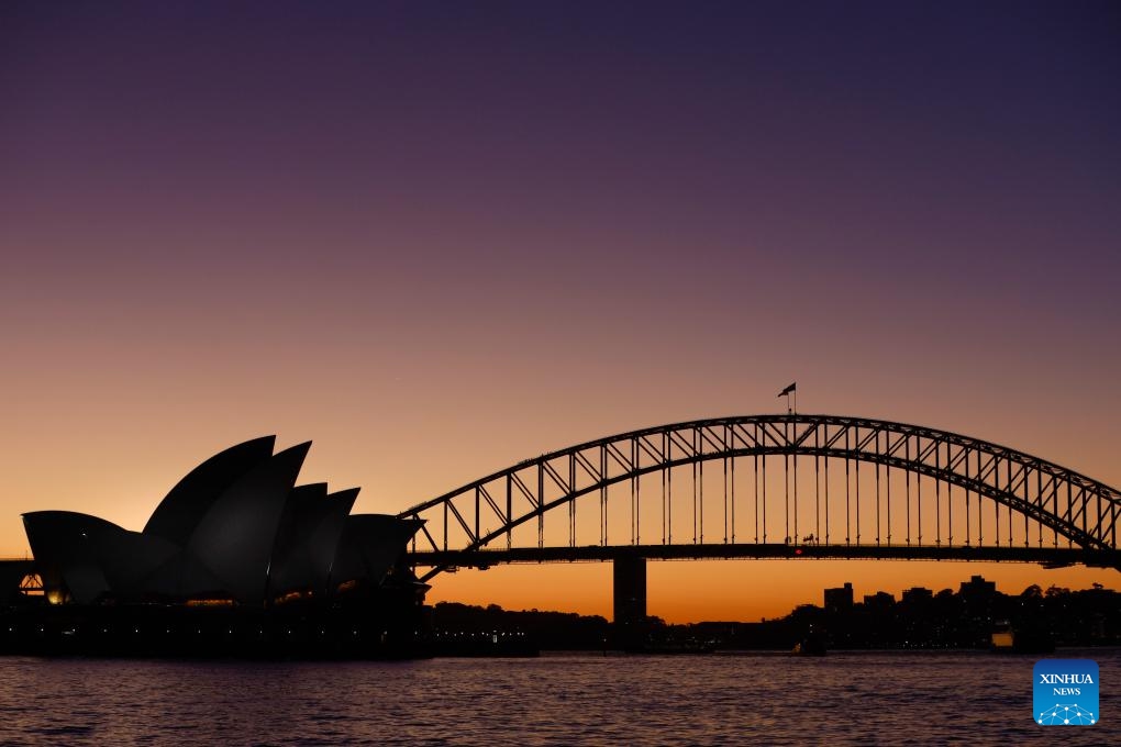 This photo taken on July 23, 2024 shows a sunset view of the Opera House and the Harbor Bridge in Sydney, Australia. (Photo: Xinhua)