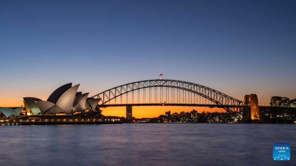 This photo taken on July 23, 2024 shows a sunset view of the Opera House and the Harbor Bridge in Sydney, Australia. (Photo: Xinhua)