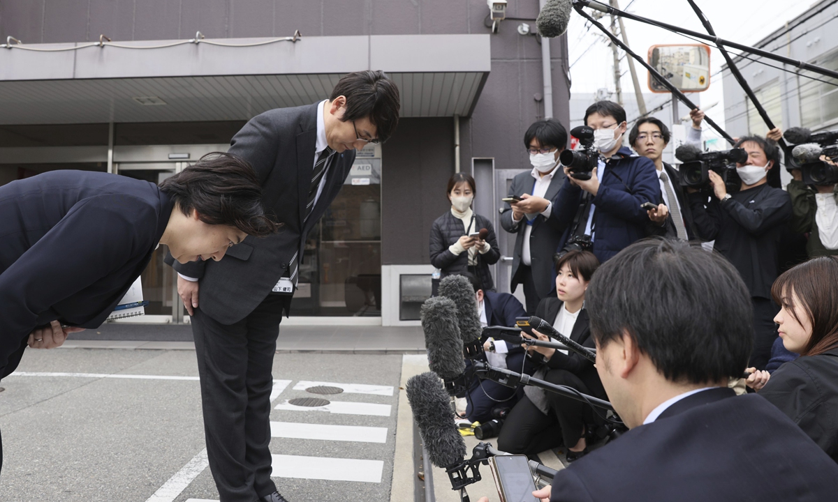 Kobayashi Pharmaceutical employees bow their head after the Japanese Ministry of Health, Labor and Welfare conducted an on-site inspection in its factory in Osaka, over the 