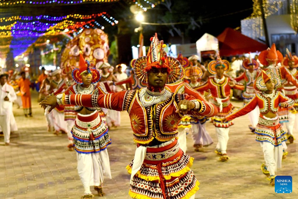 People perform traditional dances during the final day of Kataragama Perahera in Katharagama, Sri Lanka, July 21, 2024. Kataragama Perahera is an important festival in Sri Lanka. During the festival, participants stage fire-walking performances to show their devotion to Kataragama. This year the festival took place from July 7 to 21. (Photo: Xinhua)