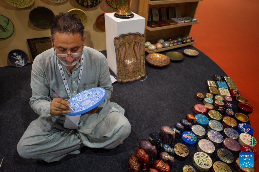 An Indian artisan makes a paper mache product at an exhibition titled Incredible India in New Delhi, India, July 22, 2024. The exhibition is set up to highlight India's rich cultural heritage, age-old civilization, geographical diversity, and tourism destinations. (Photo: Xinhua)