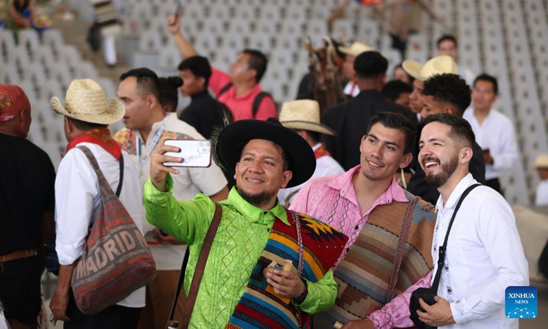 People take a selfie at the Guelaguetza Auditorium in Oaxaca City, Mexico, July 22, 2024. Guelaguetza is an annual showcase of the indigenous cultures of Mexico, featured by traditional music, dance, and food. (Photo: Xinhua)