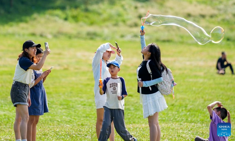 Tourists have fun at the Fairy Mountain National Forest Park in Wulong District, southwest China's Chongqing Municipality, July 22, 2024. Relying on its pleasant climate and beautiful natural environment, the Fairy Mountain scenic area, with an altitude of 1,100 to 2,033 meters, has become a popular destination for citizens to escape the sweltering summer heat. (Photo: Xinhua)