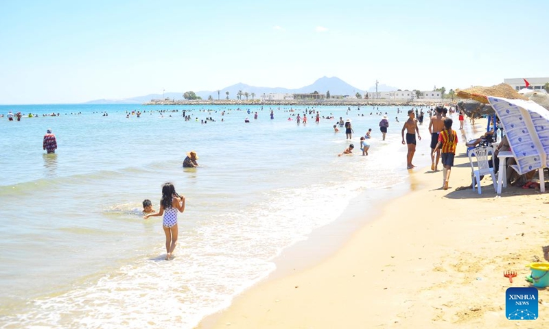 People play in water and cool off by the seaside during a heat wave in Tunis, Tunisia, July 22, 2024. (Photo: Xinhua)