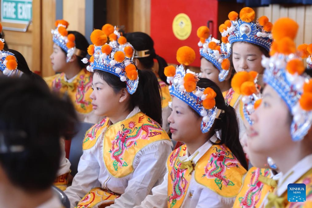 Members of China's Guangzhou Opera House Children's Choir watch a performance of students of Wellington East Girls' College in Wellington, New Zealand, July 24, 2024. Members of Guangzhou Opera House Children's Choir visited Wellington East Girls' College in New Zealand on Wednesday, and held a joint concert with the high school's choir at the opening ceremony of the new semester of the school. (Photo: Xinhua)